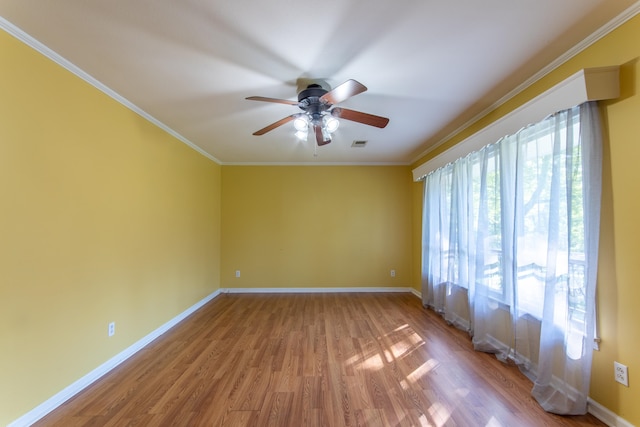 spare room featuring ceiling fan, light hardwood / wood-style flooring, and crown molding