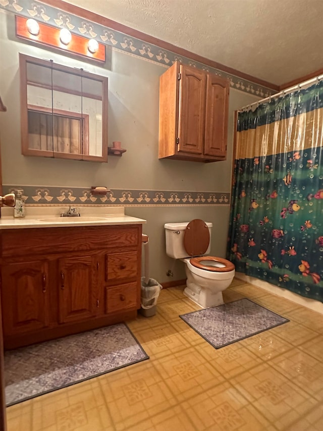 bathroom featuring curtained shower, vanity, and toilet