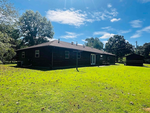 rear view of property with a yard