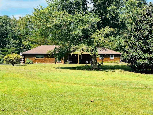 log home featuring a front lawn