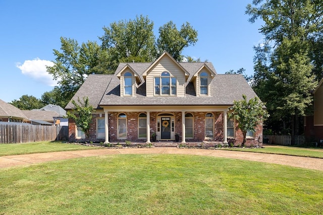 view of front facade with covered porch and a front lawn