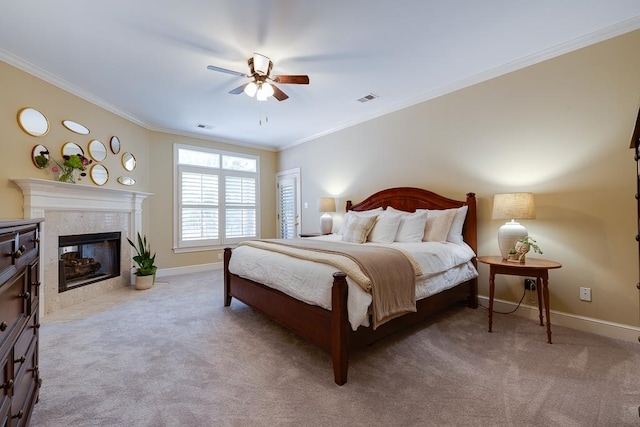 carpeted bedroom with ceiling fan, a fireplace, and ornamental molding