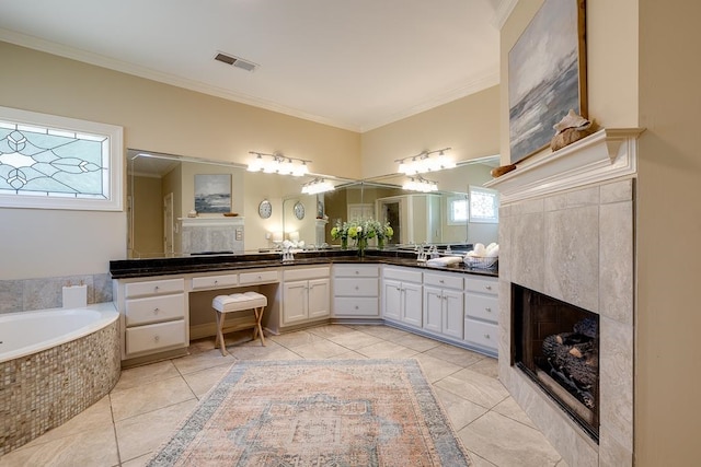 bathroom featuring vanity, crown molding, and a tiled fireplace