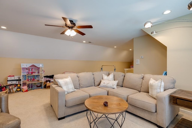 living room with ceiling fan, light colored carpet, and vaulted ceiling