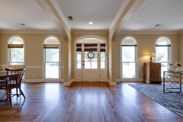 foyer entrance with dark hardwood / wood-style floors and crown molding