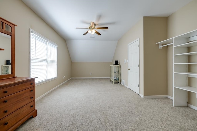 bonus room with ceiling fan, light carpet, and vaulted ceiling