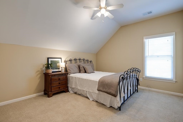 carpeted bedroom with vaulted ceiling and ceiling fan