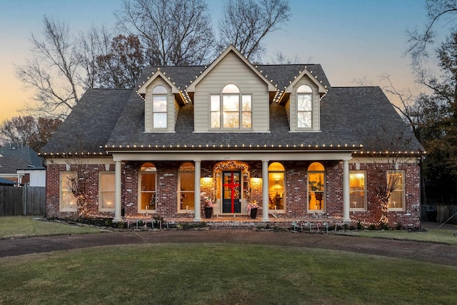 view of front of property with a lawn and a porch