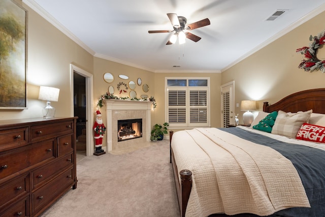 carpeted bedroom with ceiling fan and ornamental molding