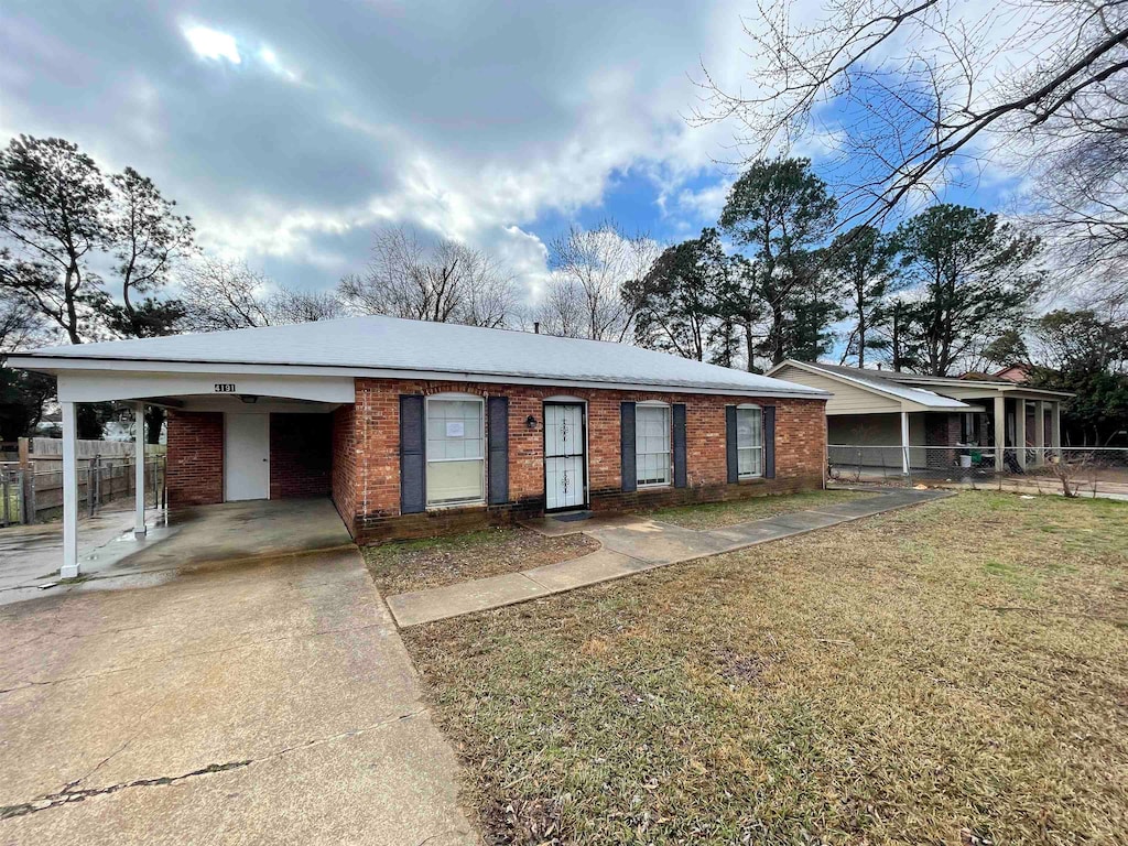 view of front facade featuring a front lawn and a carport