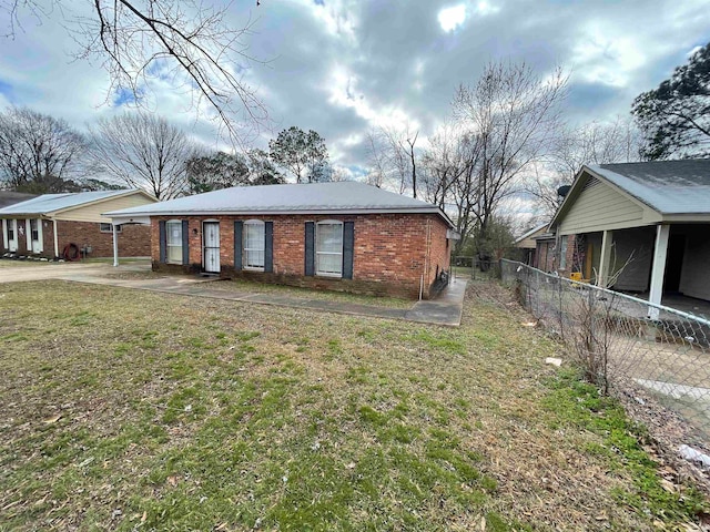 view of side of home featuring a yard