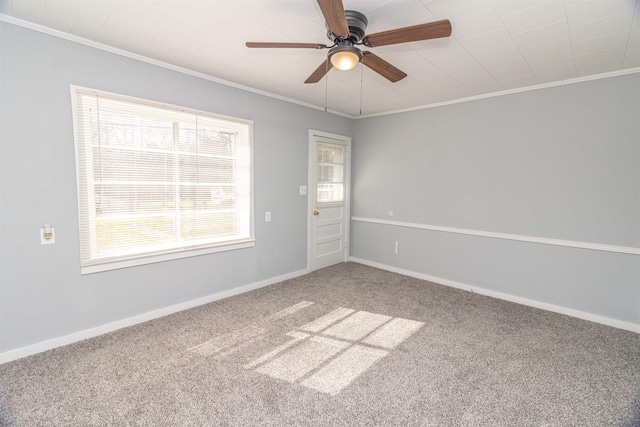 empty room featuring ornamental molding, carpet, and ceiling fan