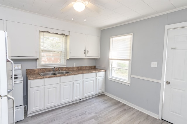 kitchen featuring white appliances, sink, light hardwood / wood-style flooring, and white cabinets