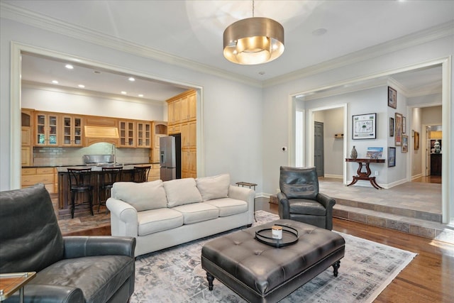 living room with light hardwood / wood-style flooring and crown molding