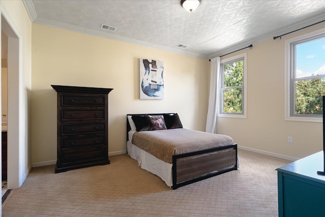 bedroom featuring a textured ceiling, light colored carpet, and crown molding