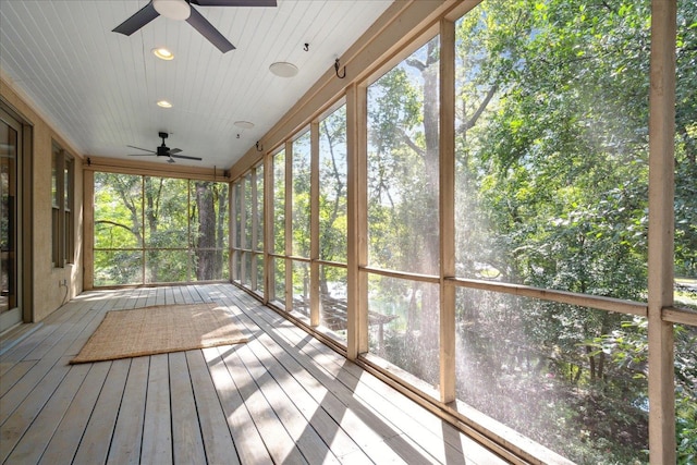 unfurnished sunroom with ceiling fan