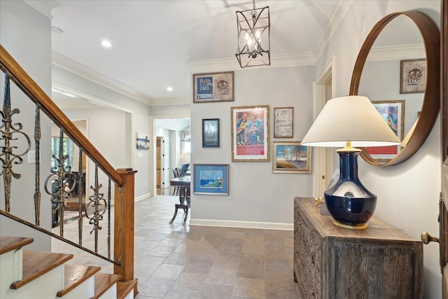 foyer entrance with an inviting chandelier and crown molding