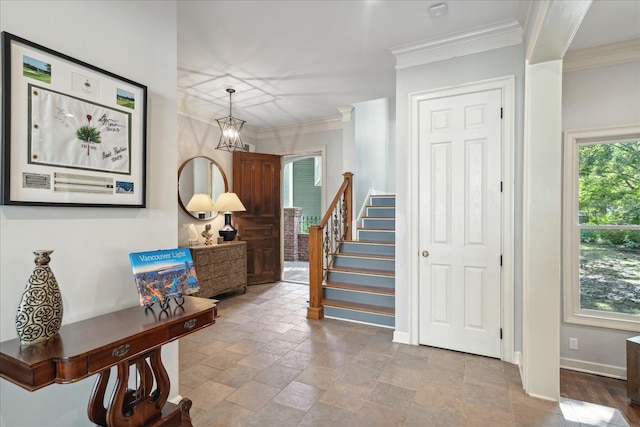 entryway featuring a notable chandelier and ornamental molding