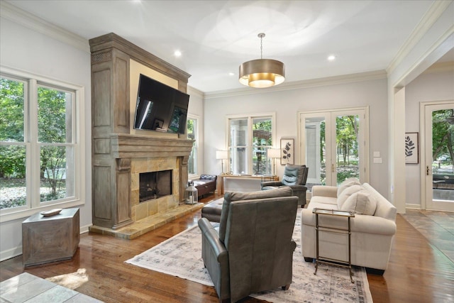 living room with crown molding, a fireplace, and hardwood / wood-style floors