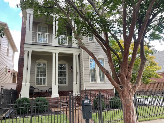 view of front facade with a balcony and covered porch