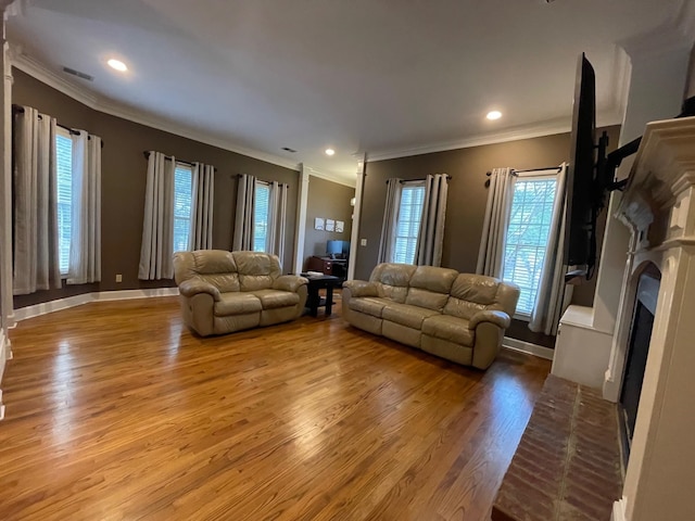 living room featuring hardwood / wood-style flooring and ornamental molding