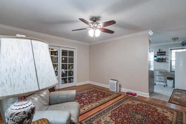 living room featuring ceiling fan, hardwood / wood-style flooring, french doors, and crown molding