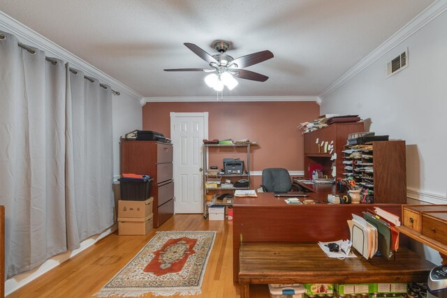 office space with ceiling fan, a textured ceiling, light wood-type flooring, and ornamental molding