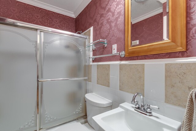 bathroom with sink, crown molding, and toilet