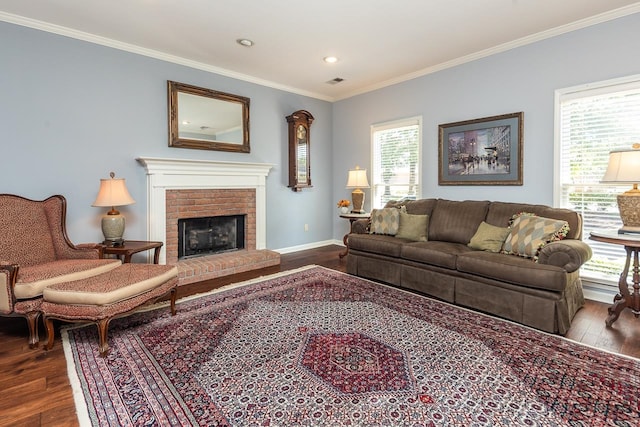 living room with crown molding, a brick fireplace, and hardwood / wood-style flooring