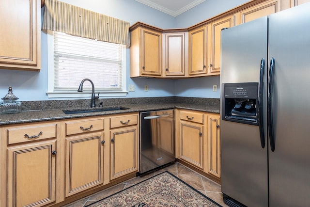 kitchen featuring ornamental molding, stainless steel appliances, dark stone countertops, and sink