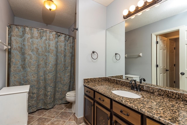 bathroom featuring tile patterned floors, a textured ceiling, vanity, and toilet