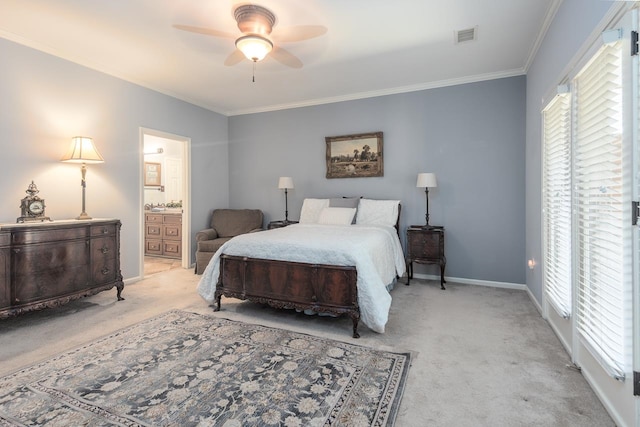 bedroom with crown molding, light carpet, ceiling fan, and ensuite bath