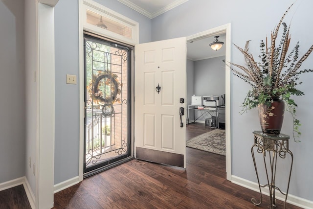 foyer entrance with ornamental molding and dark hardwood / wood-style flooring