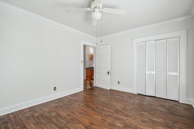 unfurnished bedroom featuring ceiling fan, a closet, crown molding, and dark wood-type flooring