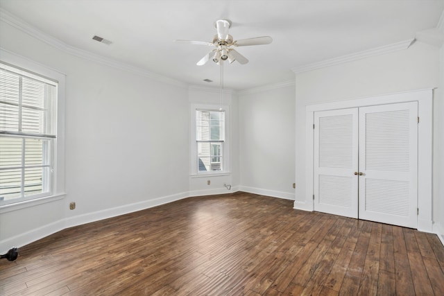 unfurnished bedroom featuring ornamental molding, dark wood-type flooring, ceiling fan, and a closet