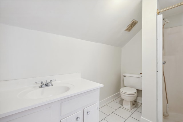 bathroom with lofted ceiling, walk in shower, tile patterned floors, vanity, and toilet