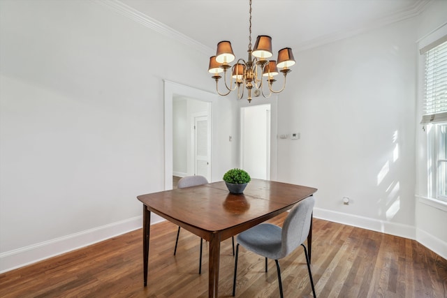 dining area featuring a notable chandelier, ornamental molding, and hardwood / wood-style flooring