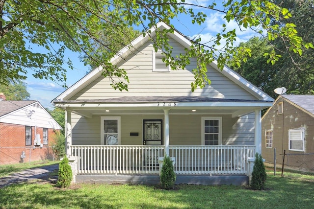 view of front of house with a front lawn and covered porch