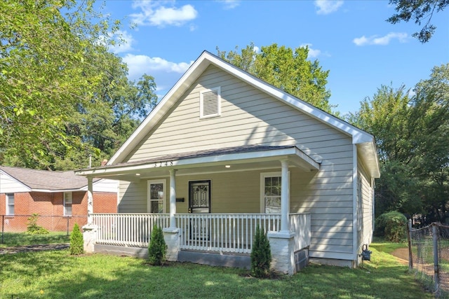 view of front of home with a front yard and covered porch