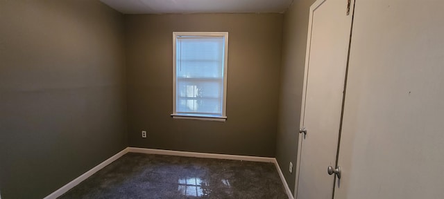 spare room with dark tile patterned floors