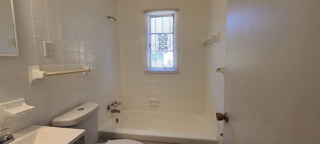 full bathroom featuring tile walls, washtub / shower combination, vanity, and toilet