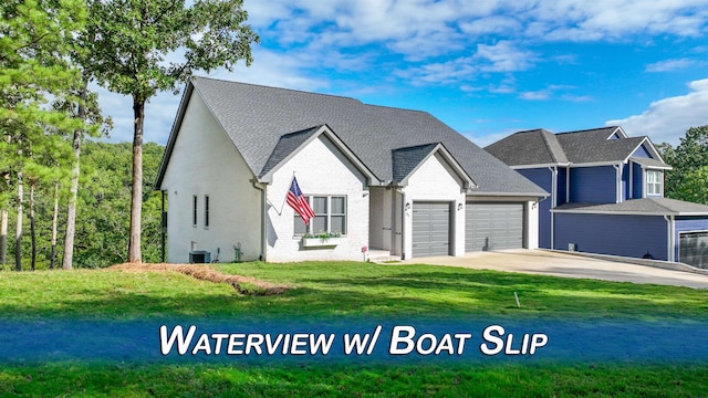 85 Breeze Pt, Savannah, TN 38372 - view of front of property featuring an attached garage, a front yard, concrete driveway, brick siding, and central AC