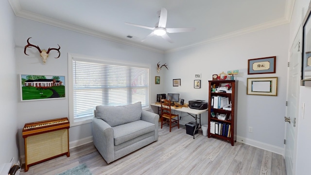 sitting room featuring ornamental molding, light wood-type flooring, and ceiling fan