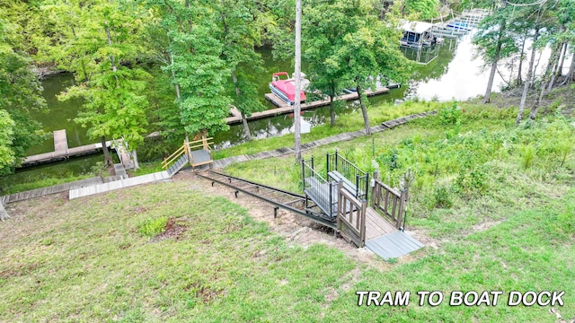 view of yard featuring a boat dock and a water view