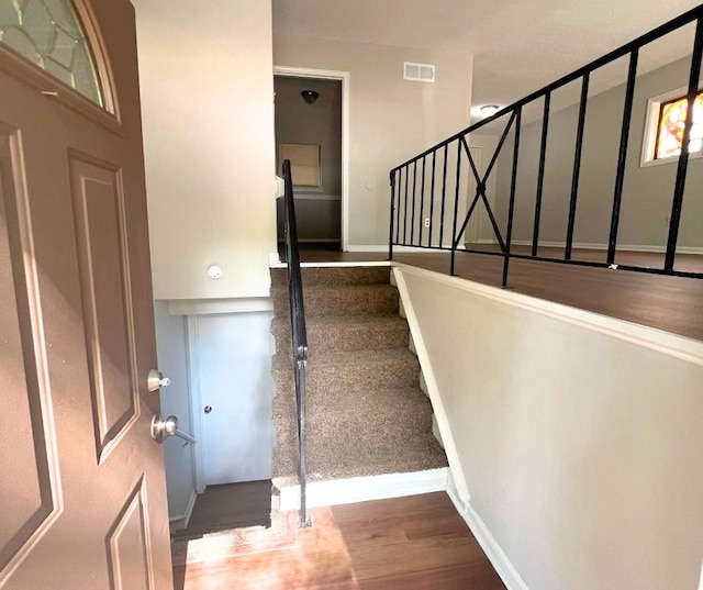 stairway with wood-type flooring