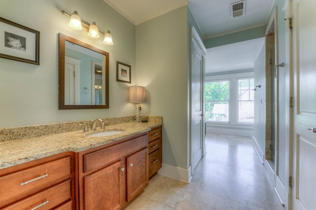 bathroom featuring ornamental molding and vanity