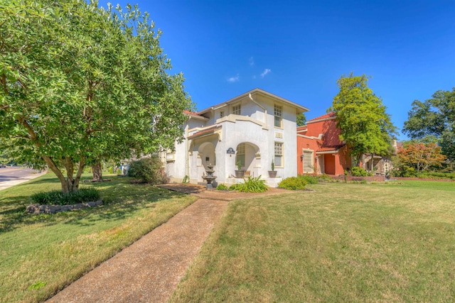 mediterranean / spanish-style house with a front yard