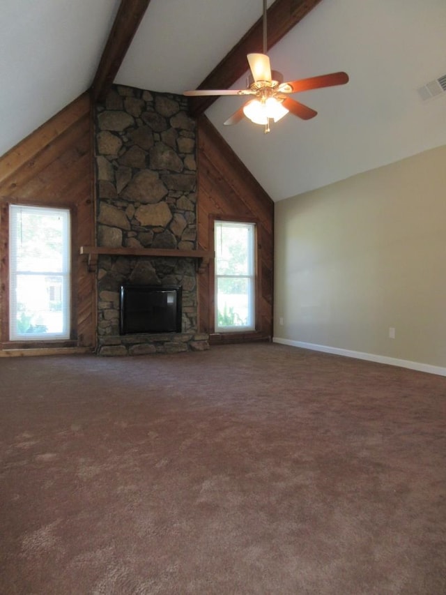 unfurnished living room featuring carpet, ceiling fan, plenty of natural light, and a fireplace