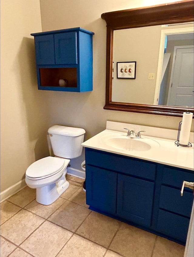 bathroom featuring vanity, tile patterned flooring, and toilet