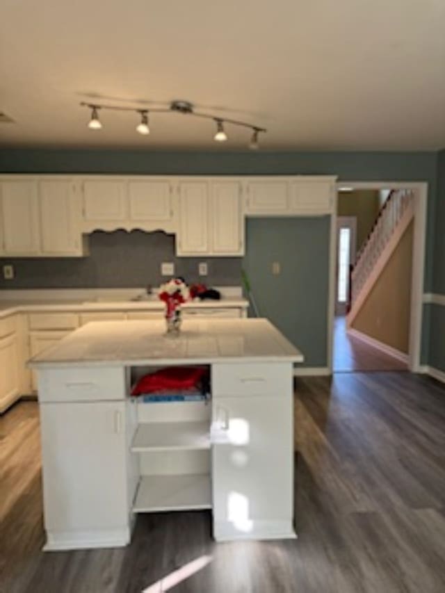 kitchen featuring white cabinets, dark hardwood / wood-style floors, and a kitchen island